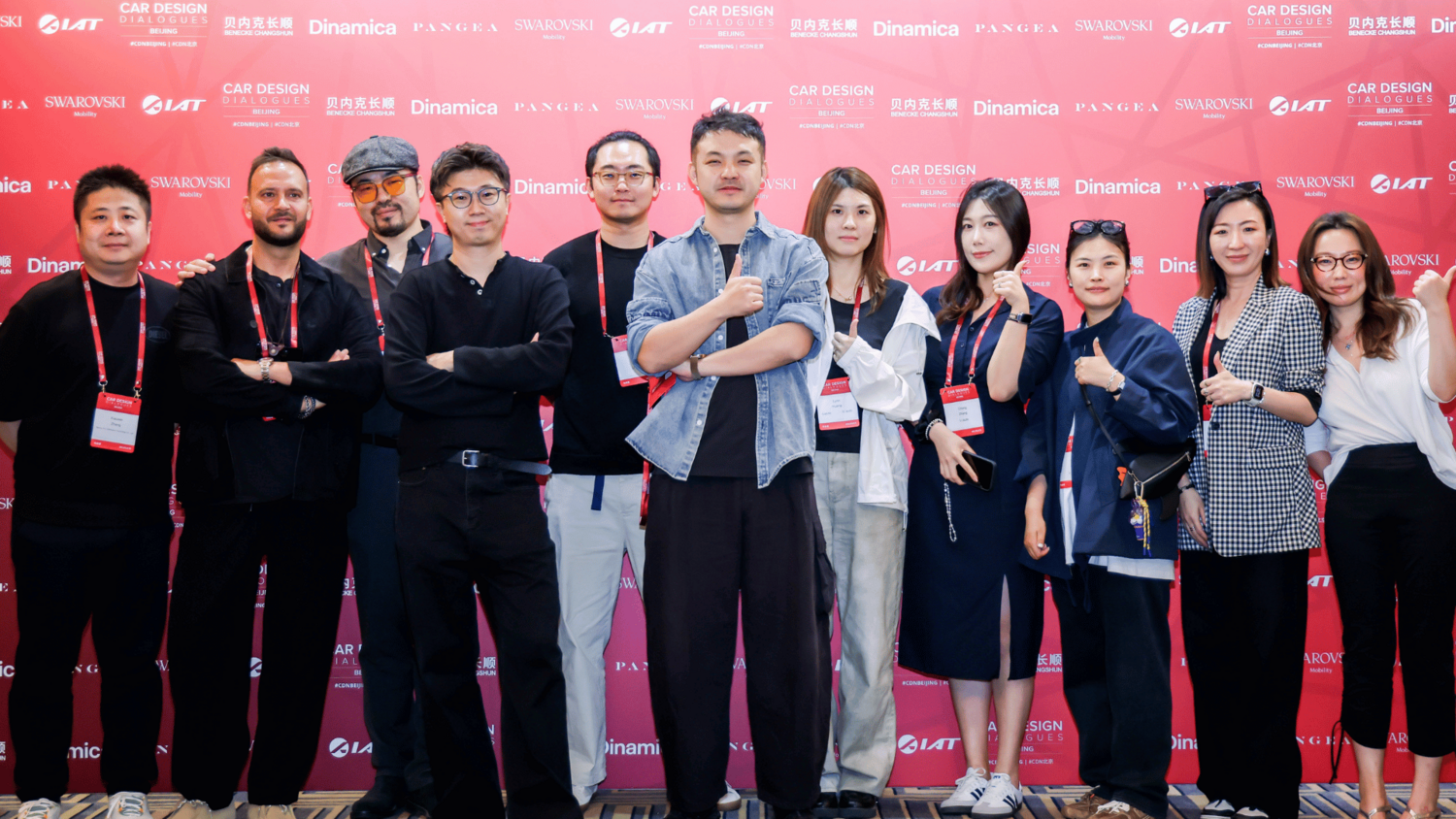 Group taking photo in front of CDD Beijing 2026 backdrop.